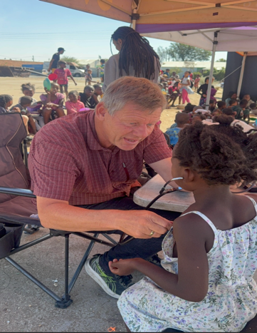 A child receiving a blood pressure check during a community health visit