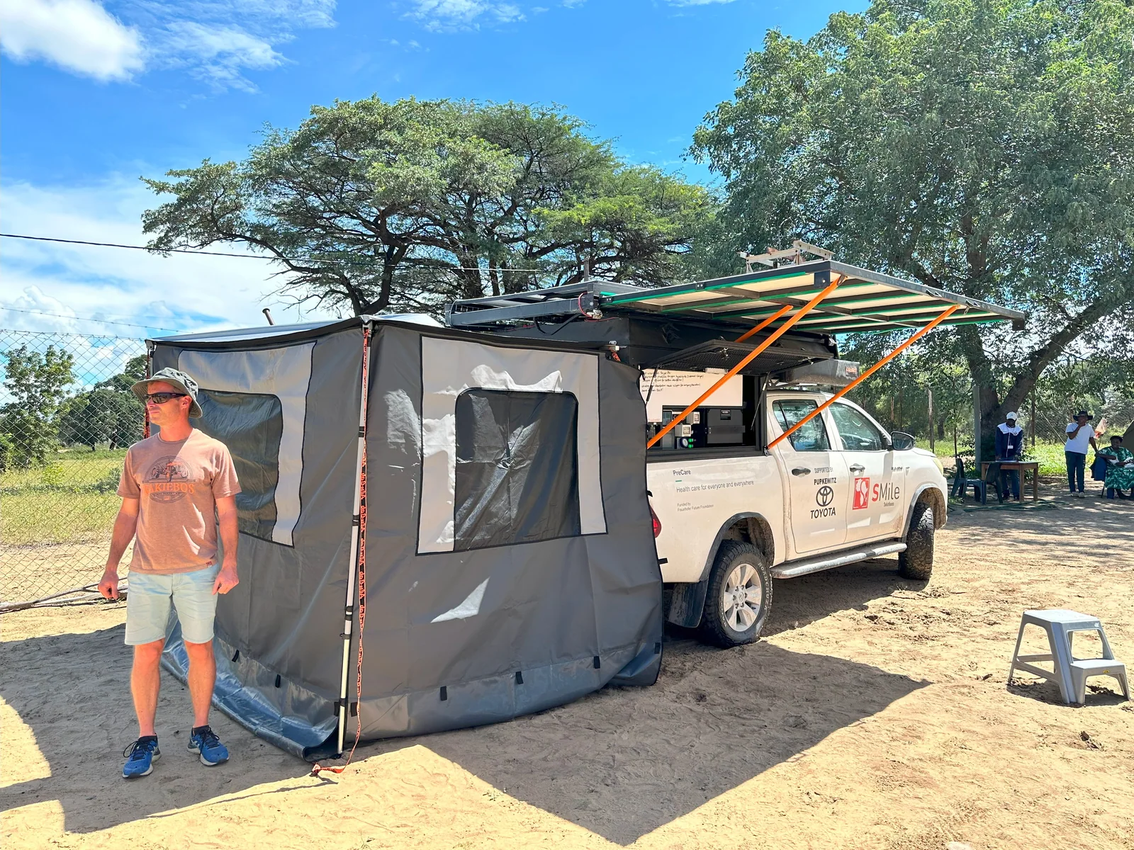 The PreCare pickup with its awning and enclosed consultation tent set up outdoors